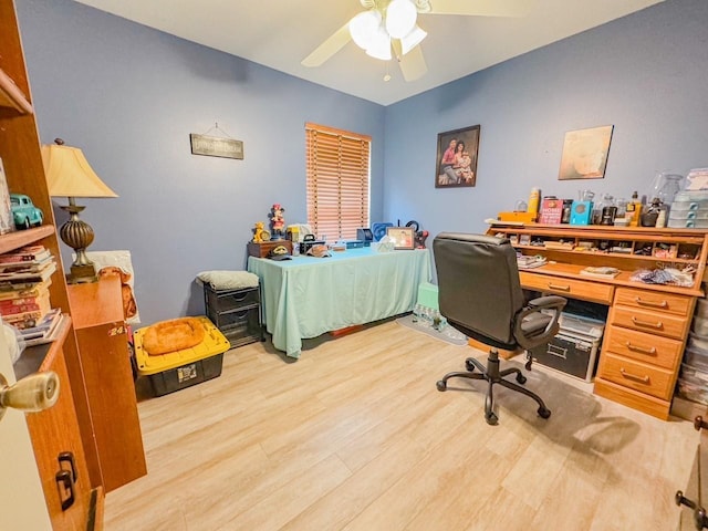 office area featuring light wood finished floors and a ceiling fan