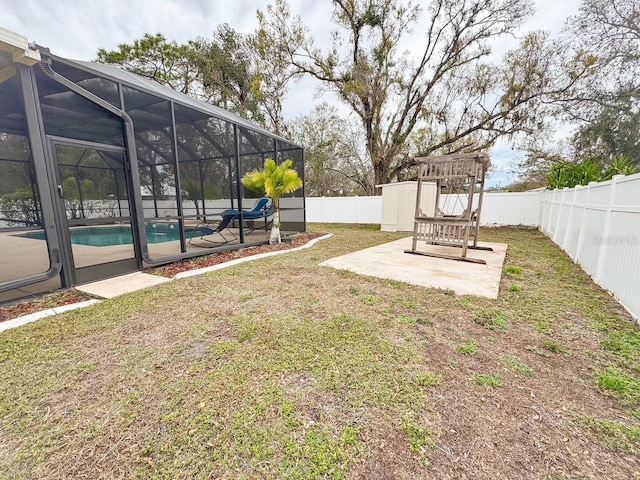 view of yard with a fenced backyard, a patio area, a lanai, and a fenced in pool