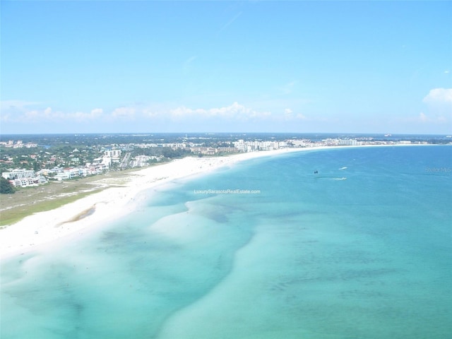 birds eye view of property featuring a view of the beach and a water view