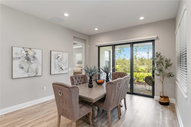 dining space with light wood-type flooring, baseboards, and recessed lighting