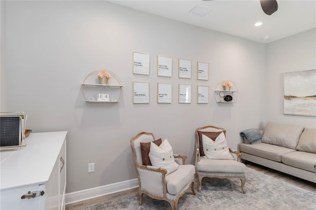 living area with recessed lighting, wood finished floors, a ceiling fan, and baseboards