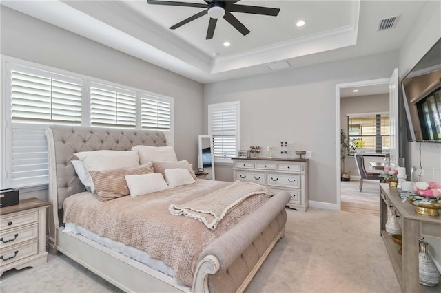 bedroom featuring a tray ceiling, recessed lighting, visible vents, and light colored carpet