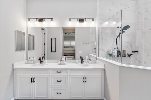 bathroom with tiled shower, ensuite bath, and a sink