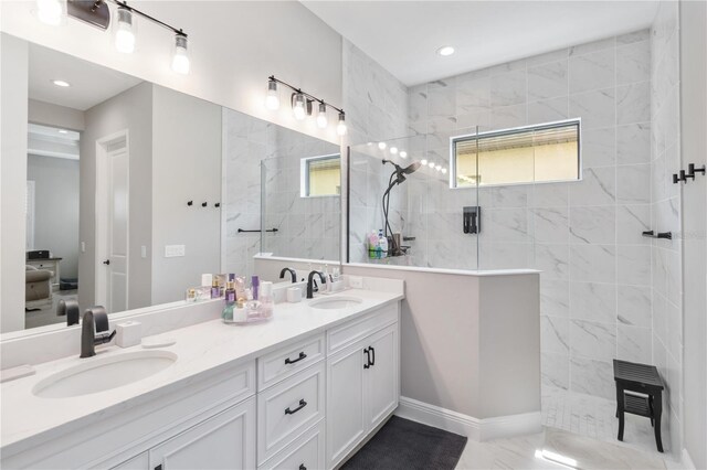 full bathroom featuring double vanity, a sink, and walk in shower