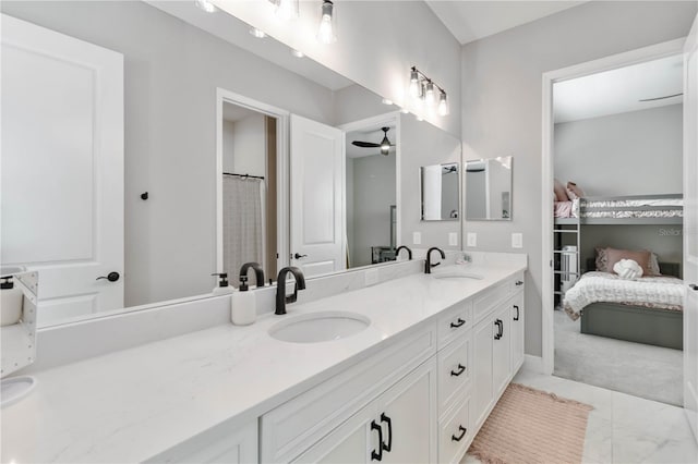 bathroom featuring ceiling fan, connected bathroom, a sink, and double vanity