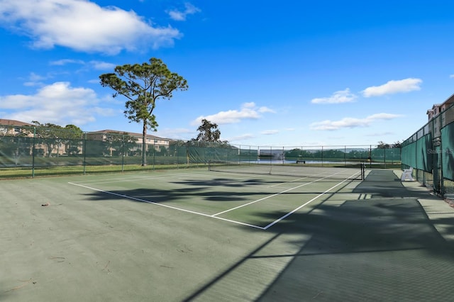 view of tennis court featuring fence