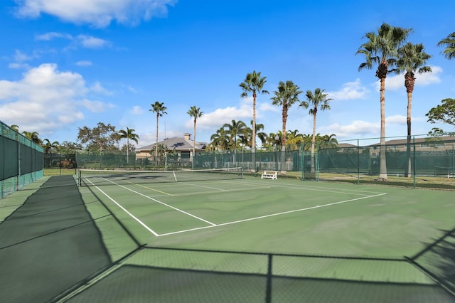 view of tennis court with fence