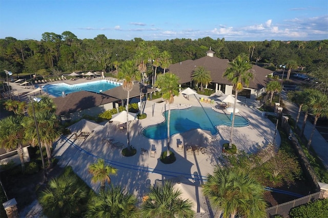 birds eye view of property featuring a view of trees