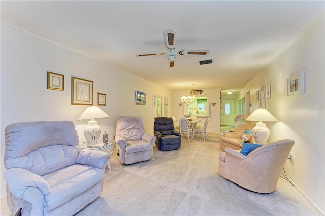 carpeted living room featuring a textured ceiling, crown molding, and ceiling fan with notable chandelier