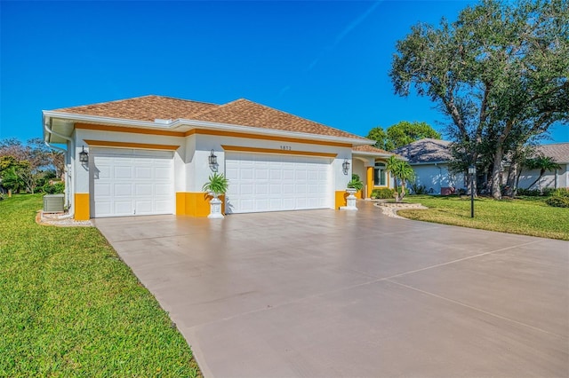 view of front of house with a front yard, an attached garage, central AC, stucco siding, and concrete driveway