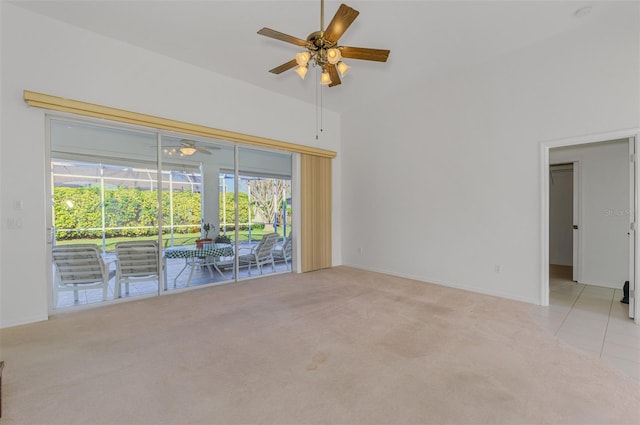 carpeted spare room with tile patterned flooring, baseboards, a sunroom, and ceiling fan