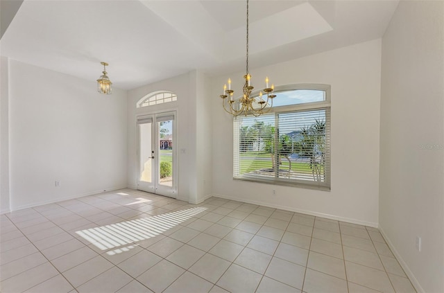 spare room with light tile patterned flooring, french doors, baseboards, and an inviting chandelier