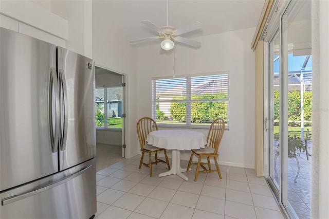 dining room featuring light tile patterned floors, baseboards, and a ceiling fan