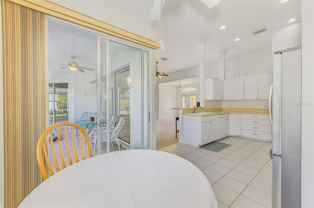 kitchen featuring a healthy amount of sunlight, visible vents, freestanding refrigerator, and ceiling fan