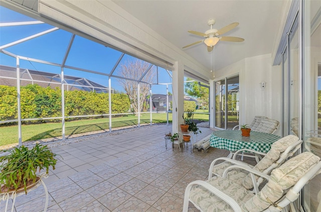 unfurnished sunroom featuring ceiling fan