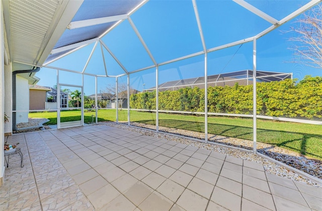 view of patio featuring glass enclosure