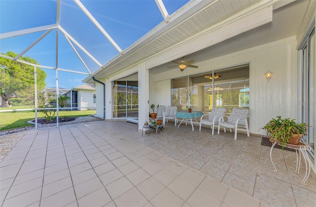 view of patio with a lanai and a ceiling fan