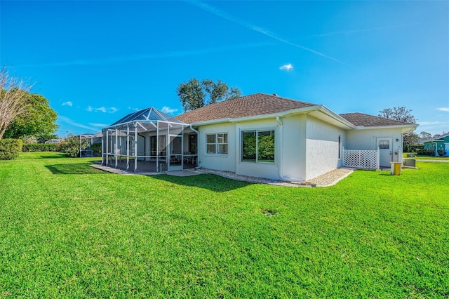 back of house with a shingled roof, central AC, glass enclosure, stucco siding, and a yard