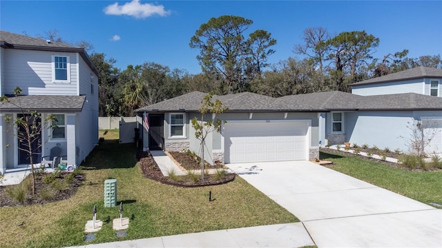 view of front of home featuring stucco siding, concrete driveway, a front yard, a garage, and stone siding