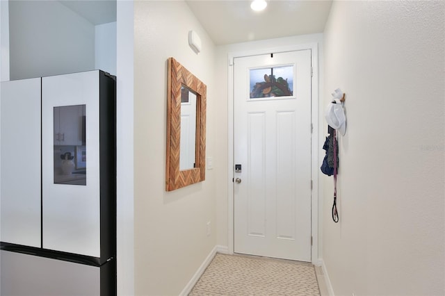 doorway to outside with baseboards