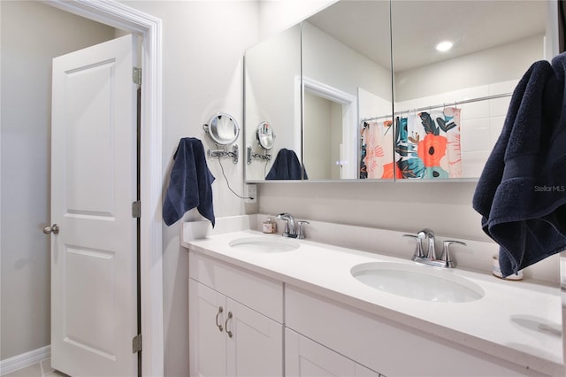 full bathroom featuring double vanity and a sink