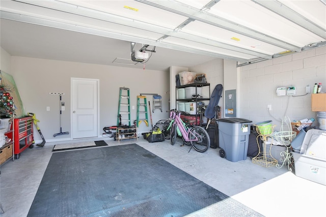 garage with a garage door opener and electric panel