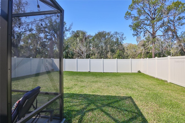 view of yard with a fenced backyard