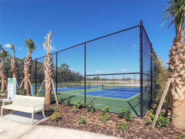 view of sport court featuring fence