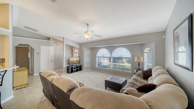 living room featuring arched walkways, visible vents, a ceiling fan, vaulted ceiling, and baseboards