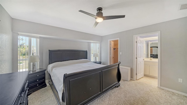 bedroom with light colored carpet, a ceiling fan, baseboards, visible vents, and a spacious closet