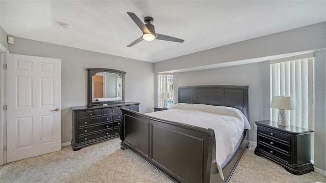 bedroom with light carpet, ceiling fan, and baseboards