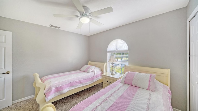 bedroom featuring carpet flooring, visible vents, ceiling fan, and baseboards