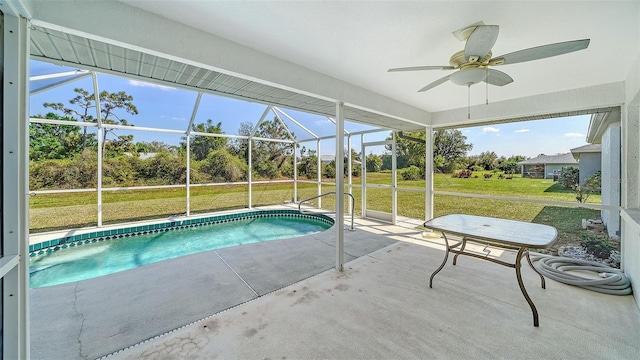 outdoor pool featuring a yard, a patio, a lanai, and a ceiling fan