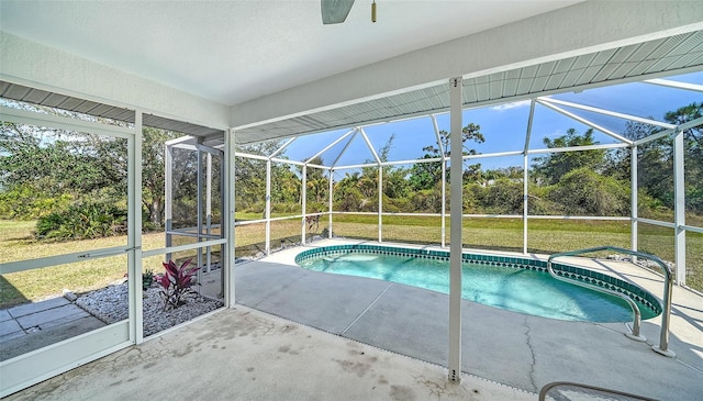 pool with a yard, glass enclosure, and a patio