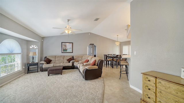 living area with visible vents, vaulted ceiling, baseboards, and ceiling fan