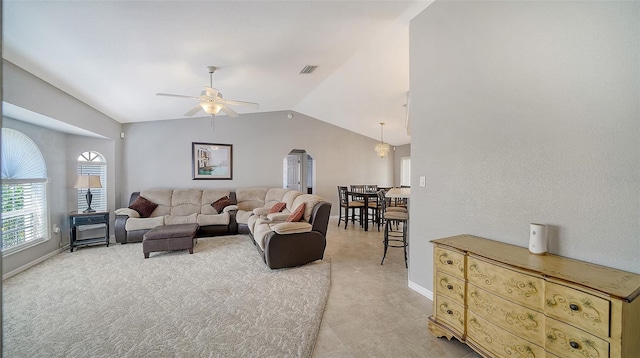 living room with vaulted ceiling, ceiling fan, visible vents, and baseboards