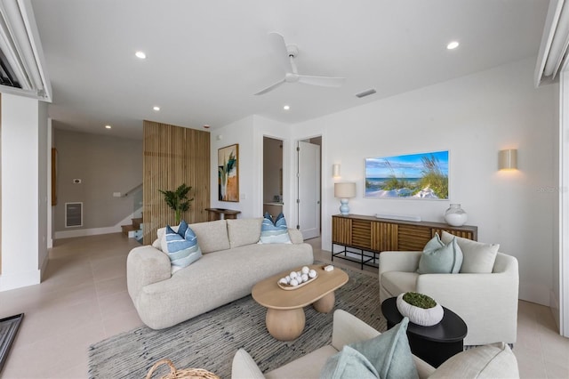 living area featuring stairway, light tile patterned floors, visible vents, recessed lighting, and ceiling fan