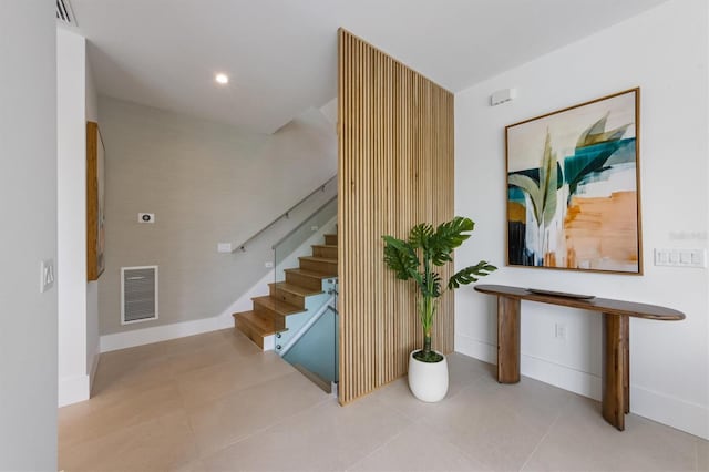 stairway featuring tile patterned floors, recessed lighting, baseboards, and visible vents