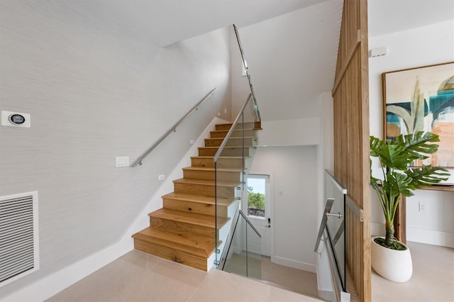 staircase featuring tile patterned floors and visible vents