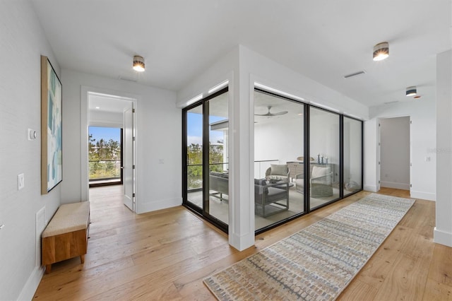 entryway featuring light wood-type flooring, visible vents, and baseboards