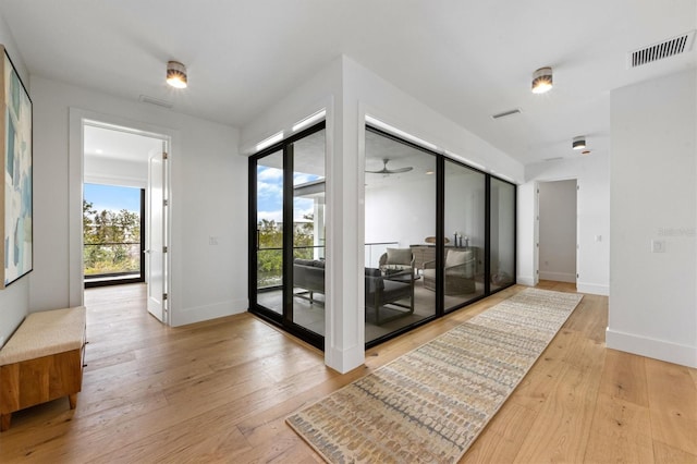 entryway with visible vents, baseboards, and hardwood / wood-style flooring