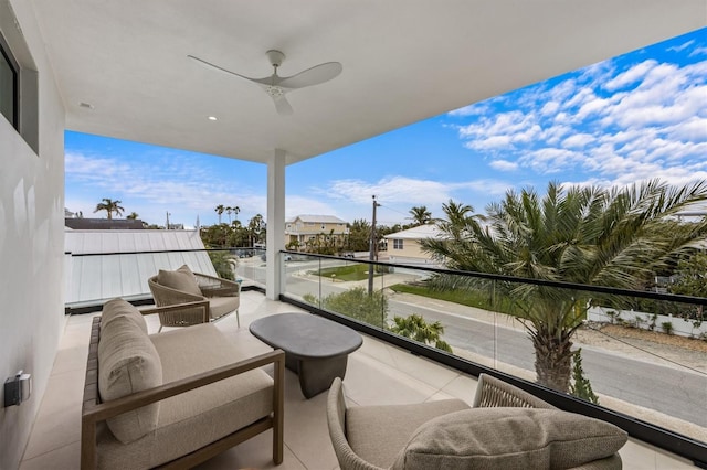 balcony with an outdoor living space and ceiling fan