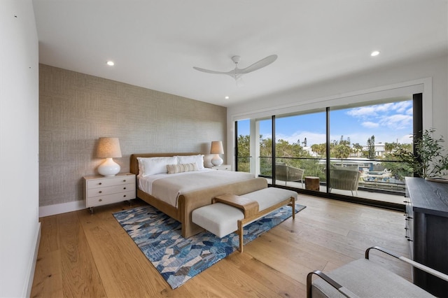 bedroom featuring wood finished floors, baseboards, wallpapered walls, recessed lighting, and access to exterior