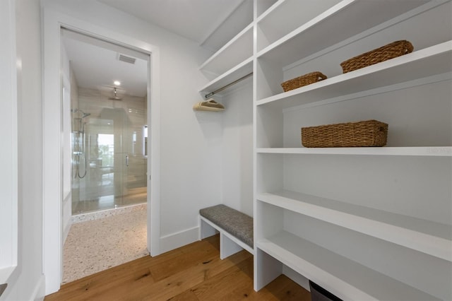 mudroom featuring wood finished floors, visible vents, and baseboards