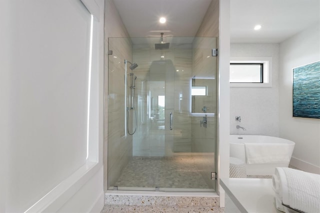 full bath with recessed lighting, a freestanding tub, baseboards, and a stall shower