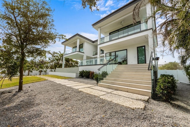 view of front of property featuring fence and stucco siding