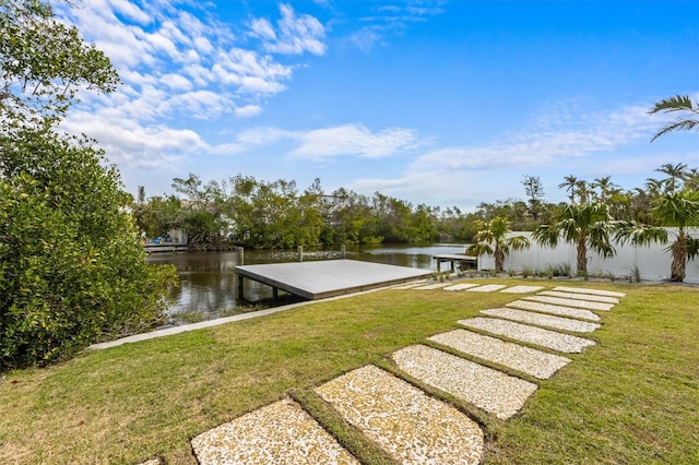 dock area featuring a lawn and a water view