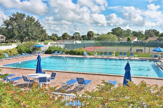 pool featuring a patio and fence