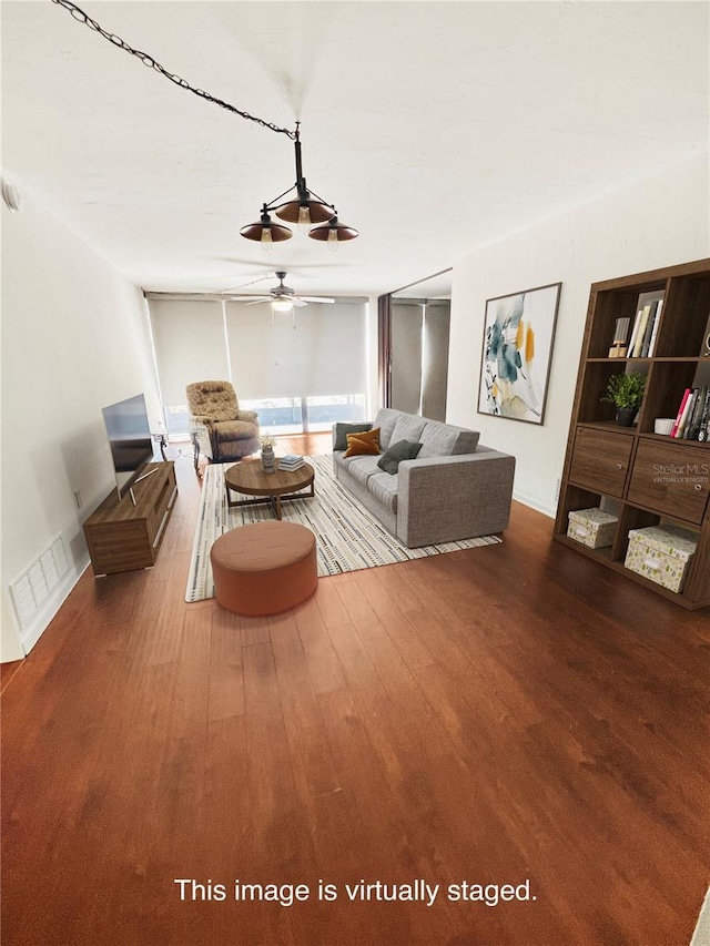 living room featuring ceiling fan, wood finished floors, and visible vents