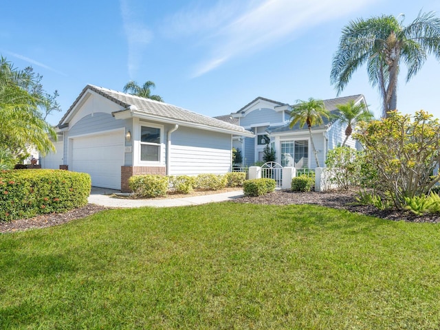 ranch-style home featuring an attached garage, brick siding, and a front yard